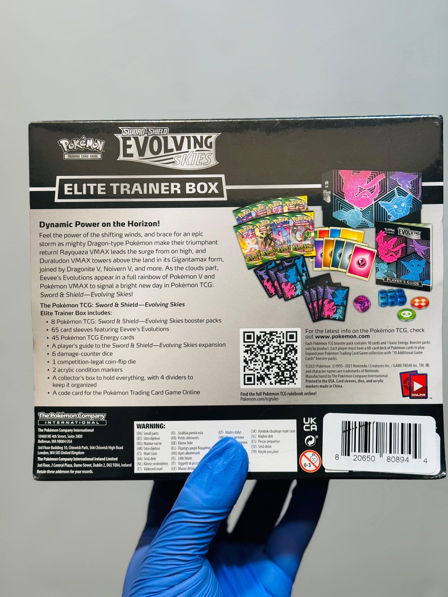 BlueGloveTCG Pokemon Evolving Skies ETB set box featuring Espeon artwork, with booster packs, sleeves, and accessories inside.