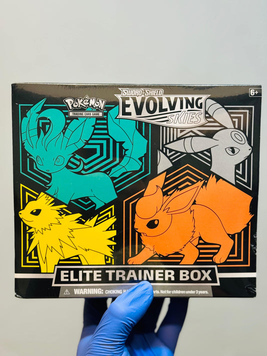 Pokemon Evolving Skies Elite Trainer Box by BlueGloveTCG featuring Espeon artwork and game accessories inside.