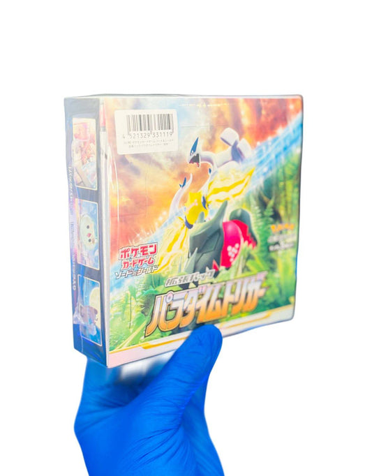 Sealed BlueGloveTCG Paradigm Trigger booster box with colorful packaging and unopened booster packs, ready for trading card game collection.